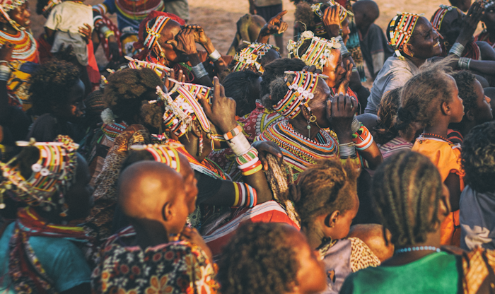 Maasai community gathered in traditional beaded dress and colorful shukas