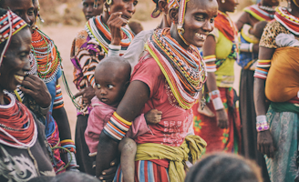 group of people standing on brown ground