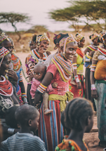 A warm photo of Martha Choco speaking with community members in a rural village setting