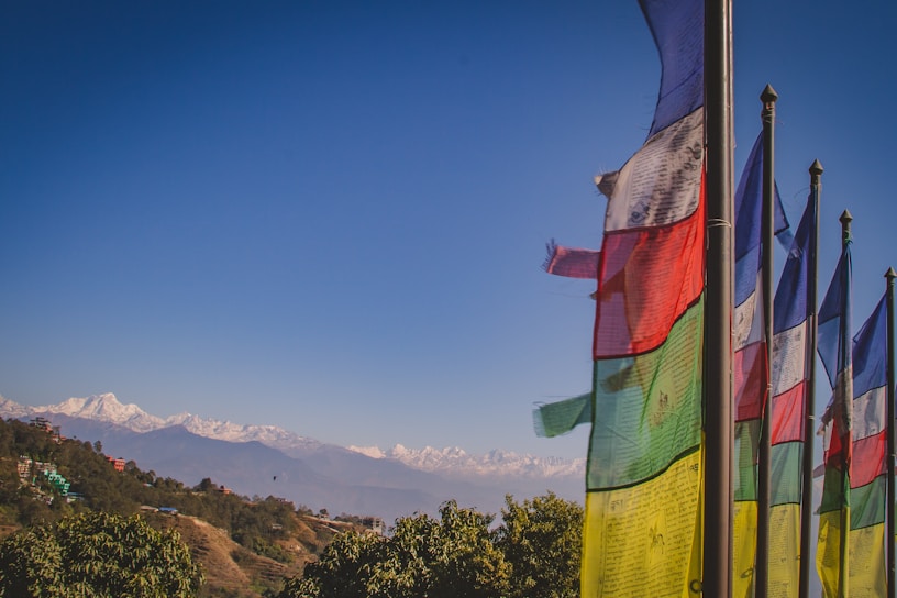 A vibrant sunset over the serene mountains of Bhutan, with prayer flags fluttering in the breeze.