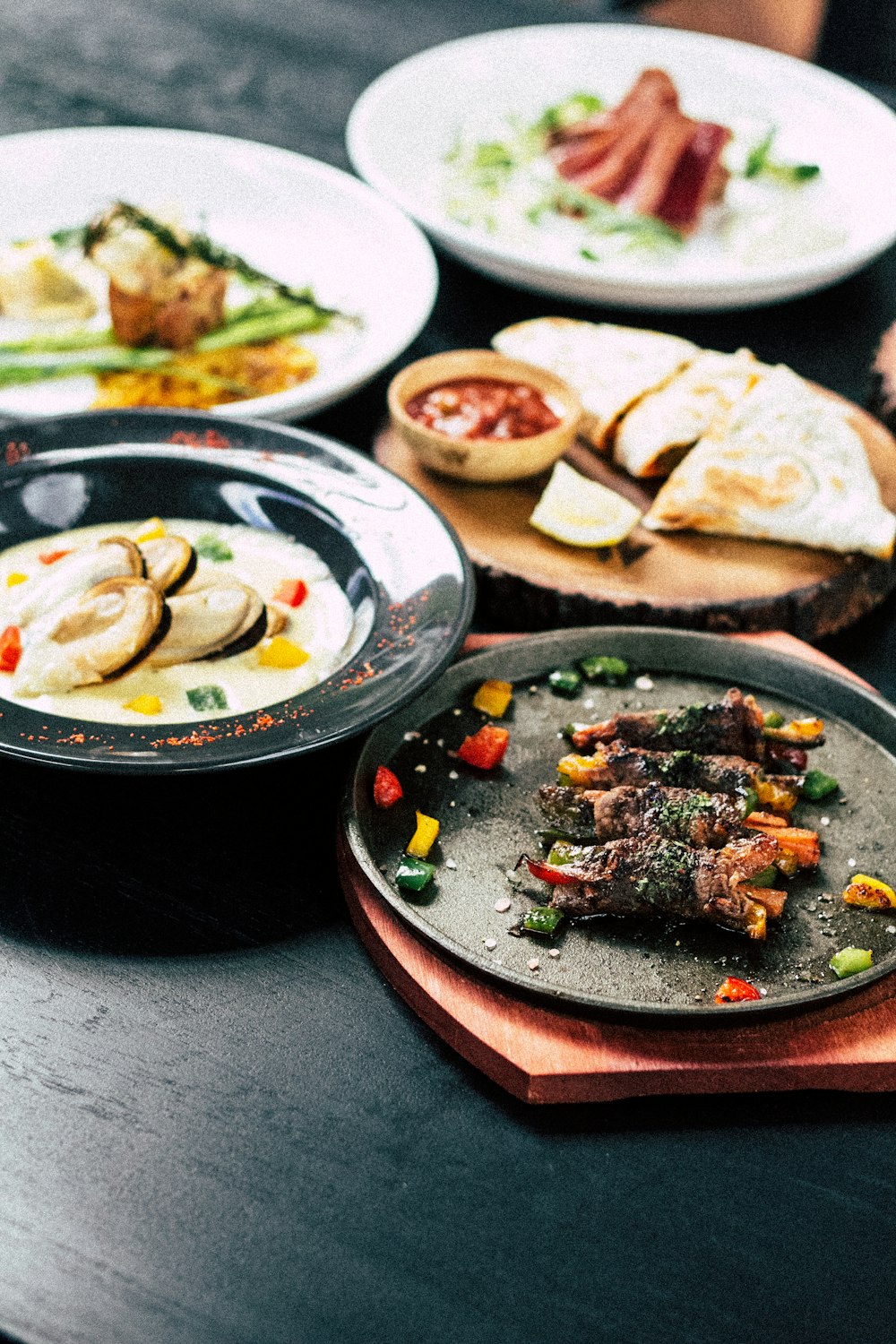 cooked food on top of black and white ceramic plates