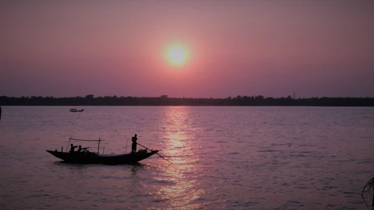 A small group enjoying a boat ride along the Rio de Janeiro coastline during sunset.