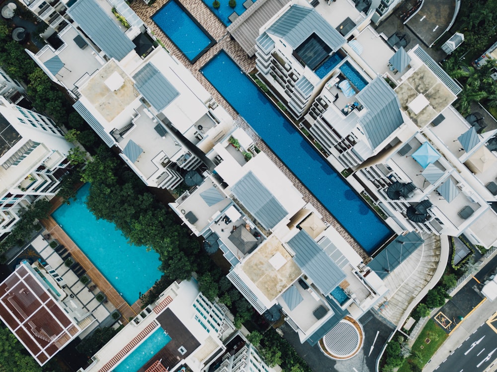 aerial photography of white concrete buildings with swimming pools