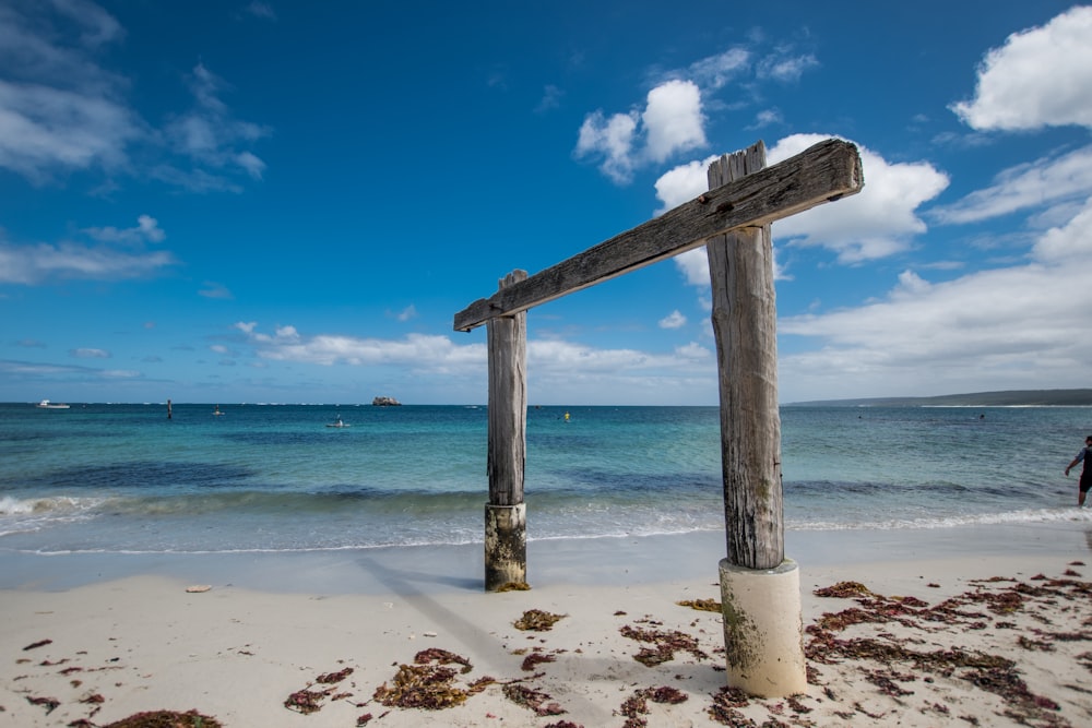 photography of brown wooden frame beside seashore during daytime