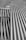 A collection of metallic pipes aligned in parallel and creating a pattern of curves and lines, giving a sense of industrial design.