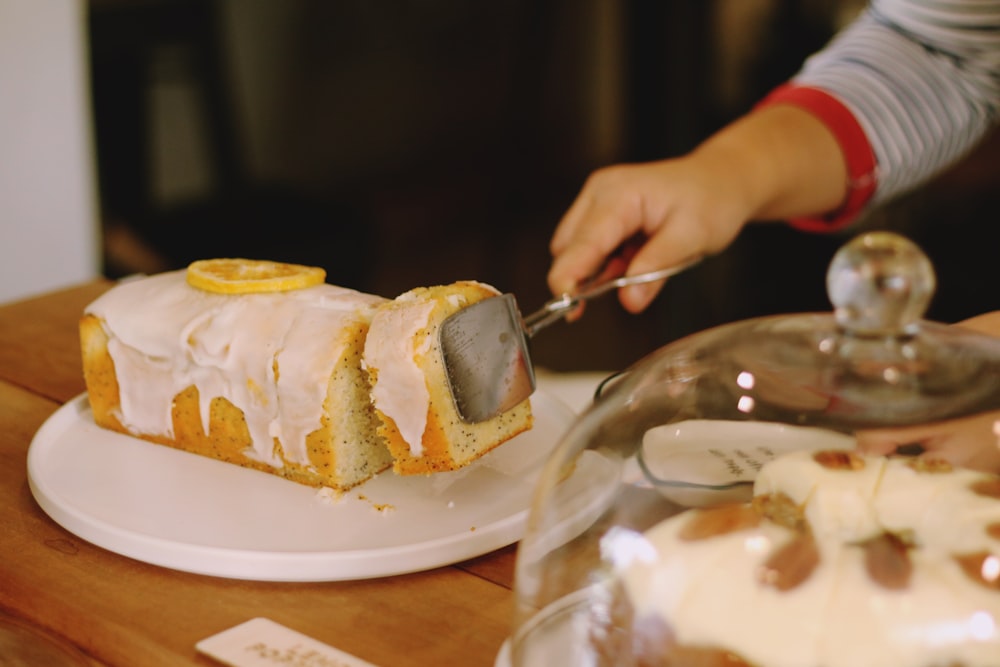 person holding gray tong taking slice of bread