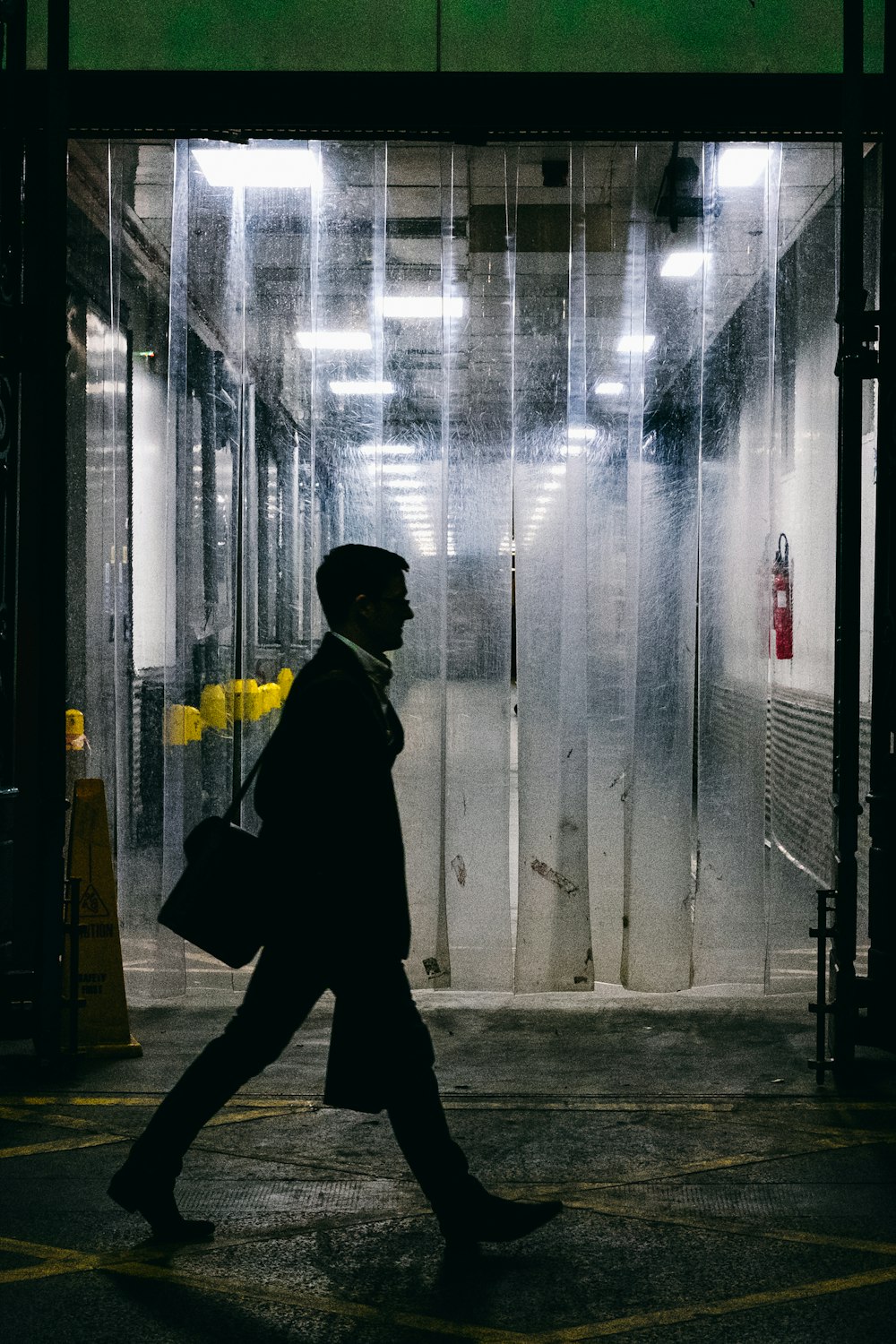 man walking in front of car wash garage