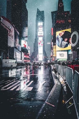 street photography,how to photograph neon snowstorm.; group of people behind barricades on sidewalk during nighttime