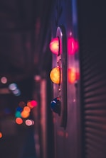 Close-up of glowing neon buttons on a dark futuristic interface.