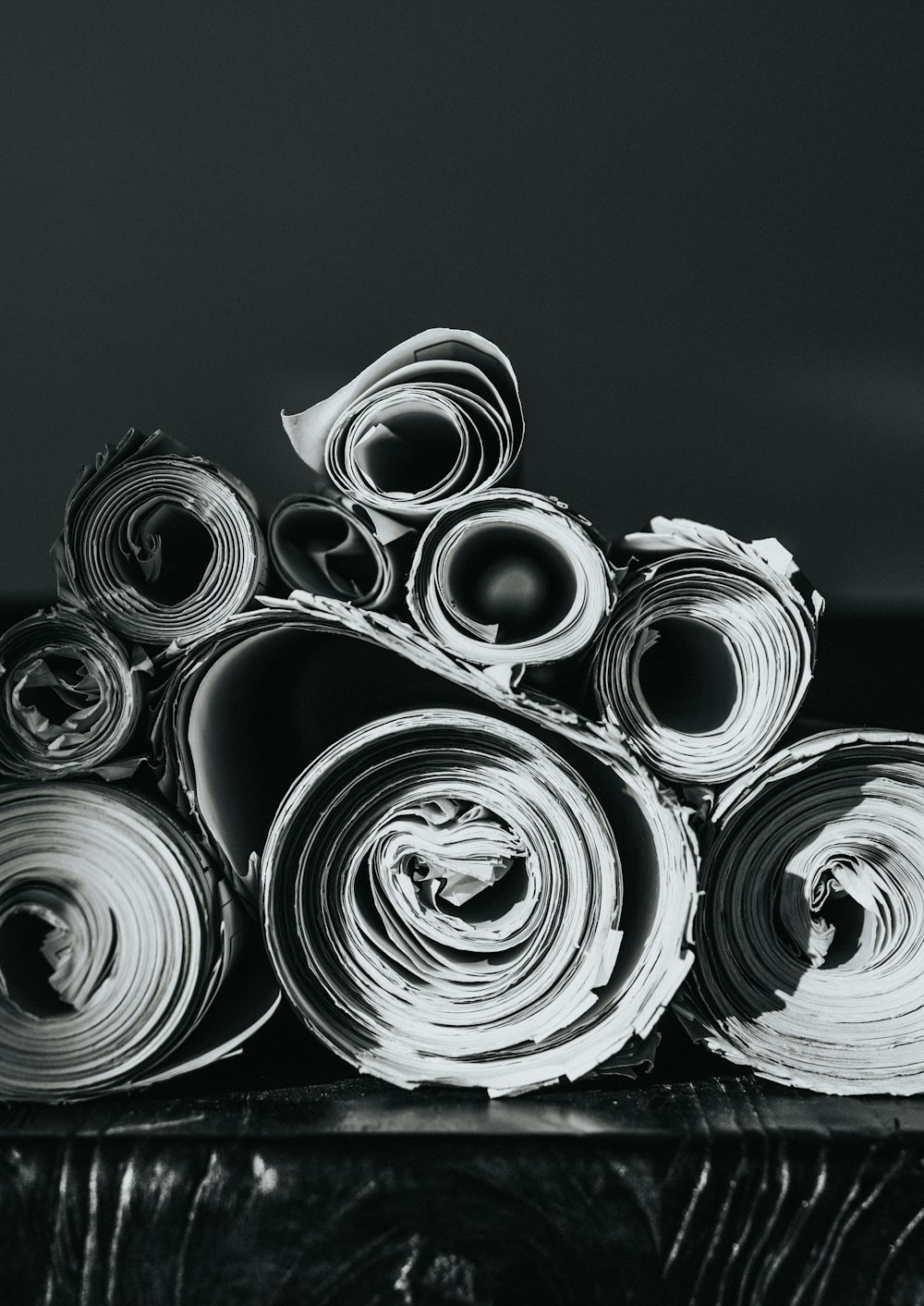 grayscale photo of rolled papers