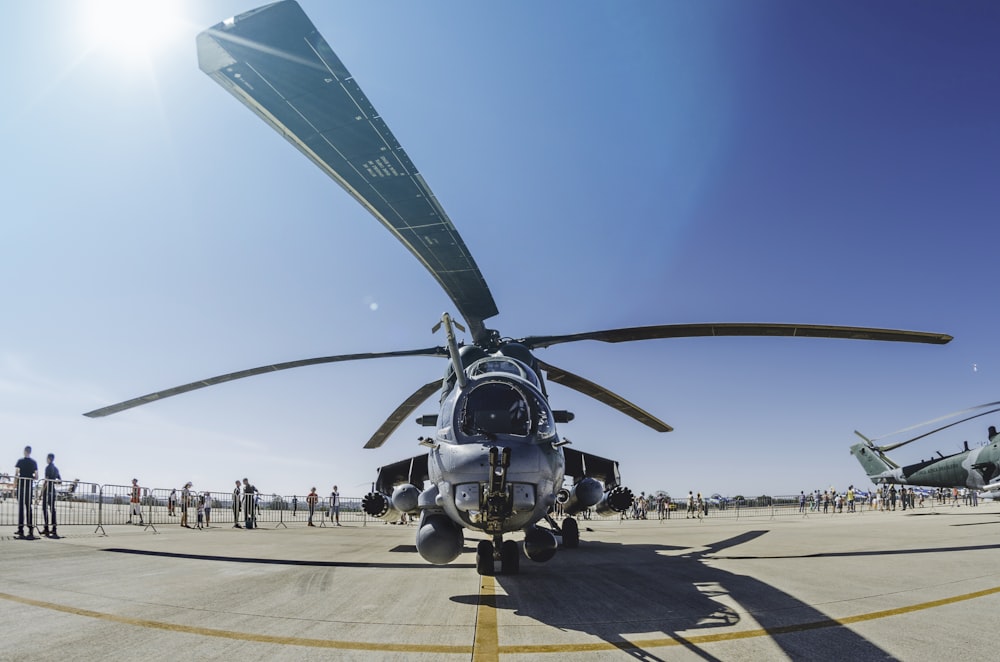 people walking and standing near gray helicopter