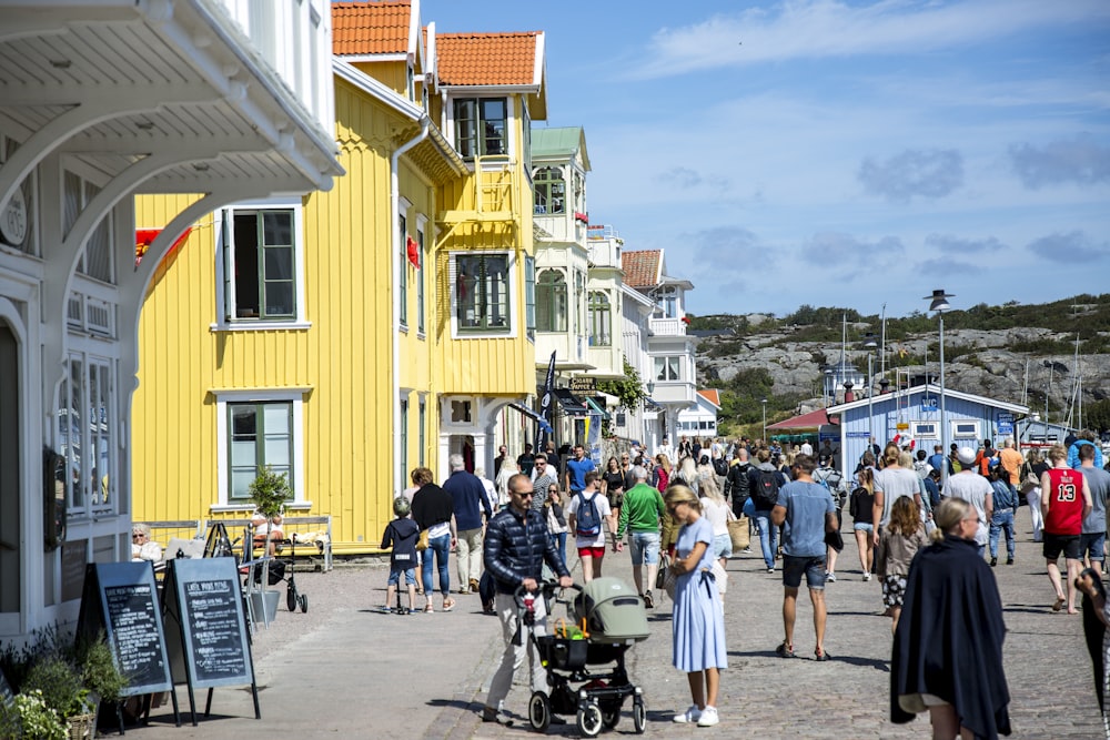 people walking in the streets near establishment building during daytime