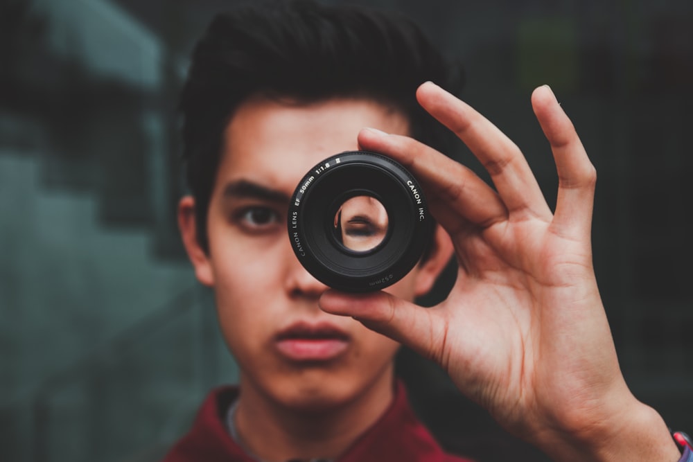 selective focus photography of man wearing red top