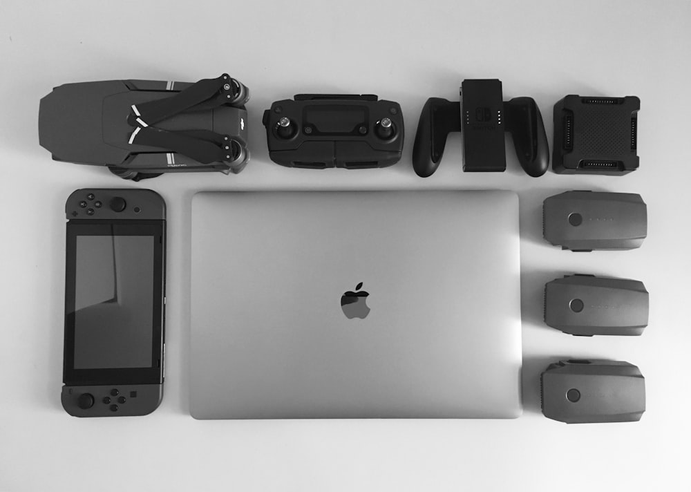 MacBook Pro near black Nintendo Switch, and game controller set