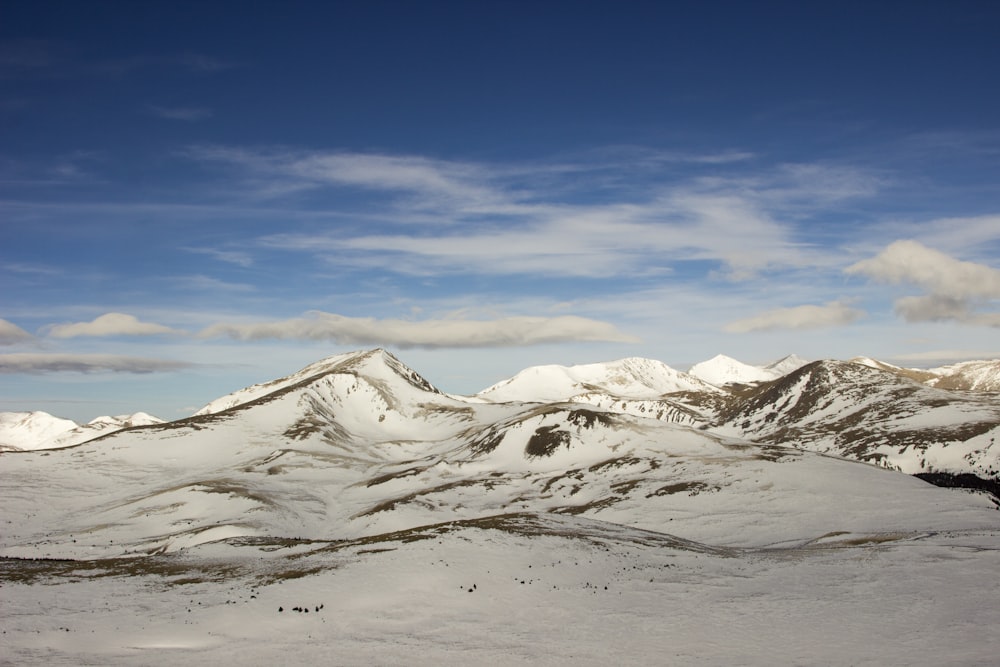 mountains covered with snows under white cloudy sky