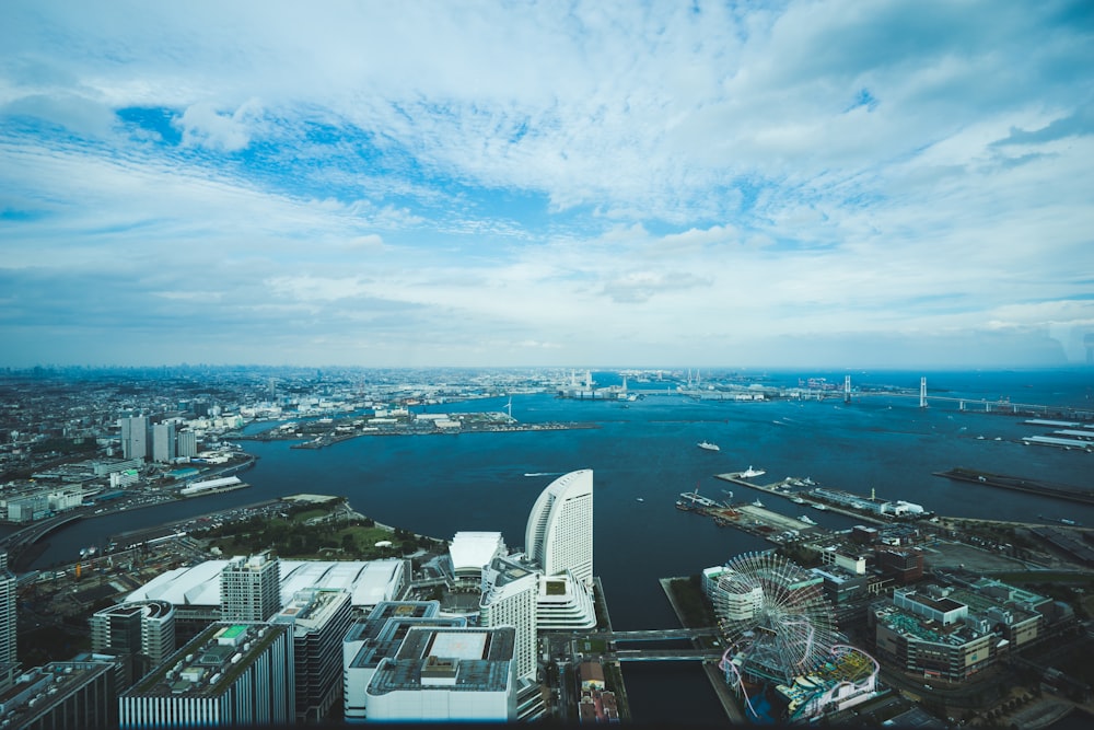 bird's eye view of city beside wide body of water during daytime