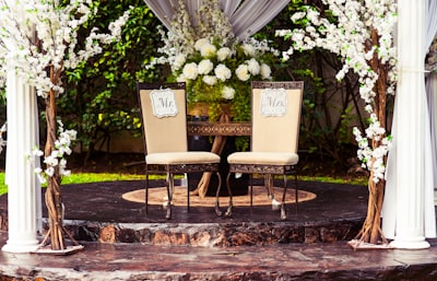 two black steel chairs beside table ceremony teams background