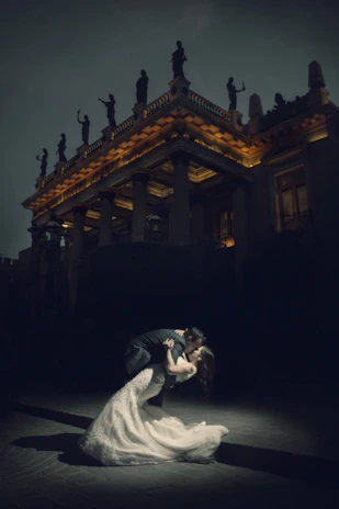 Couple dancing under romantic lights on a Provençal estate terrace at night.