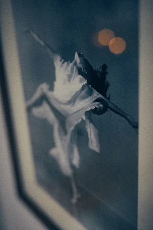 Dynamic photo of a dancer mid-spin under soft stage lights, evoking energy and grace.