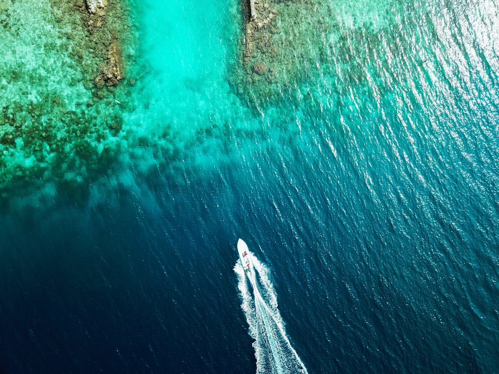 aerial view of boat sailing through island