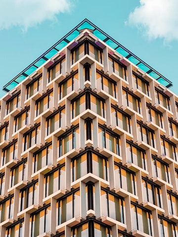 brown and black concrete building under the blue sky during daytime