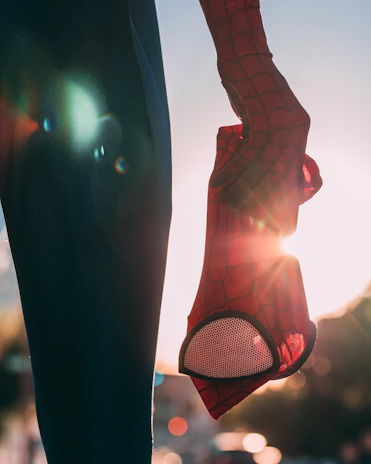 Dynamic shot of a Spider-Man mask angled to showcase its sleek, modern design and red detailing.