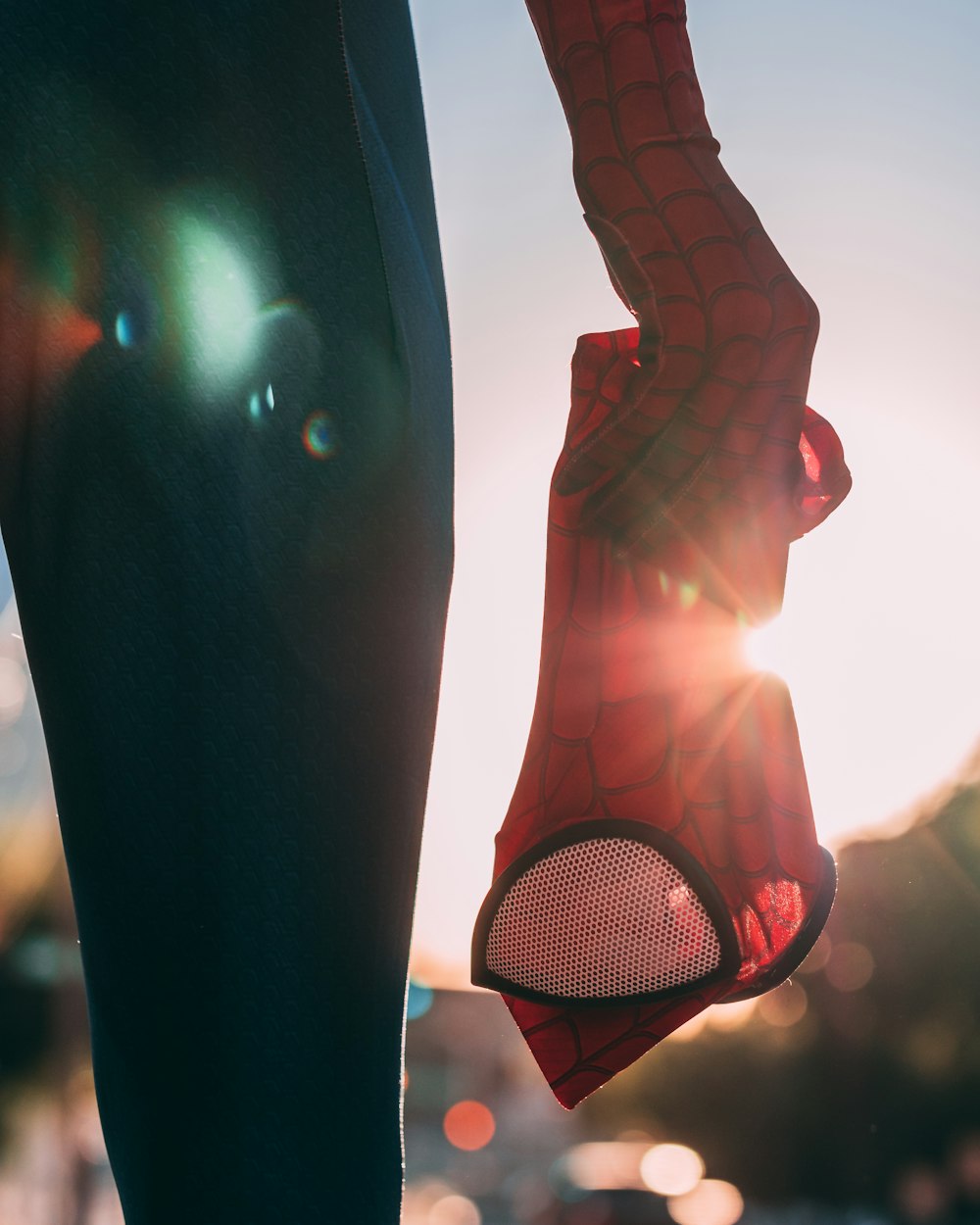 person holding Spider-Man mask