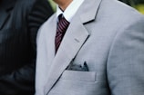 man wearing gray notched lapel suit jacket standing