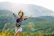 A joyful woman standing confidently with a sunrise behind her, symbolizing new beginnings.