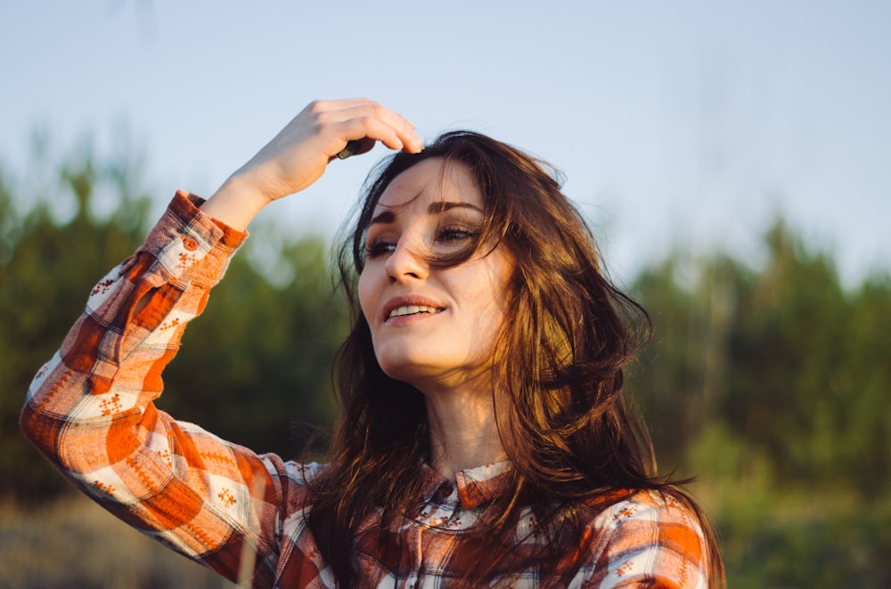 selective focus photography of woman touching her head