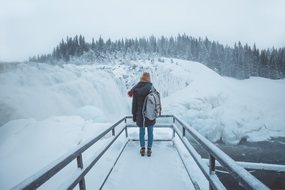 person standing on pier during winter