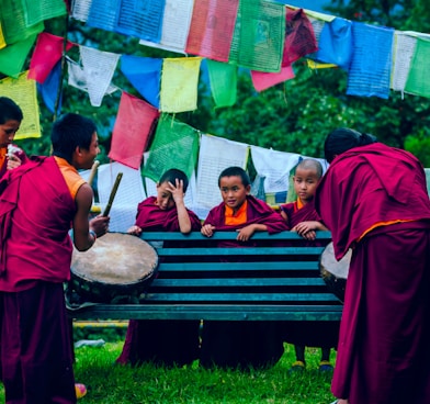 boys playing drums near towels at daytime