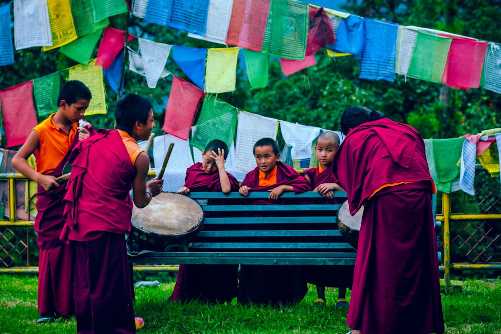 boys playing drums near towels at daytime