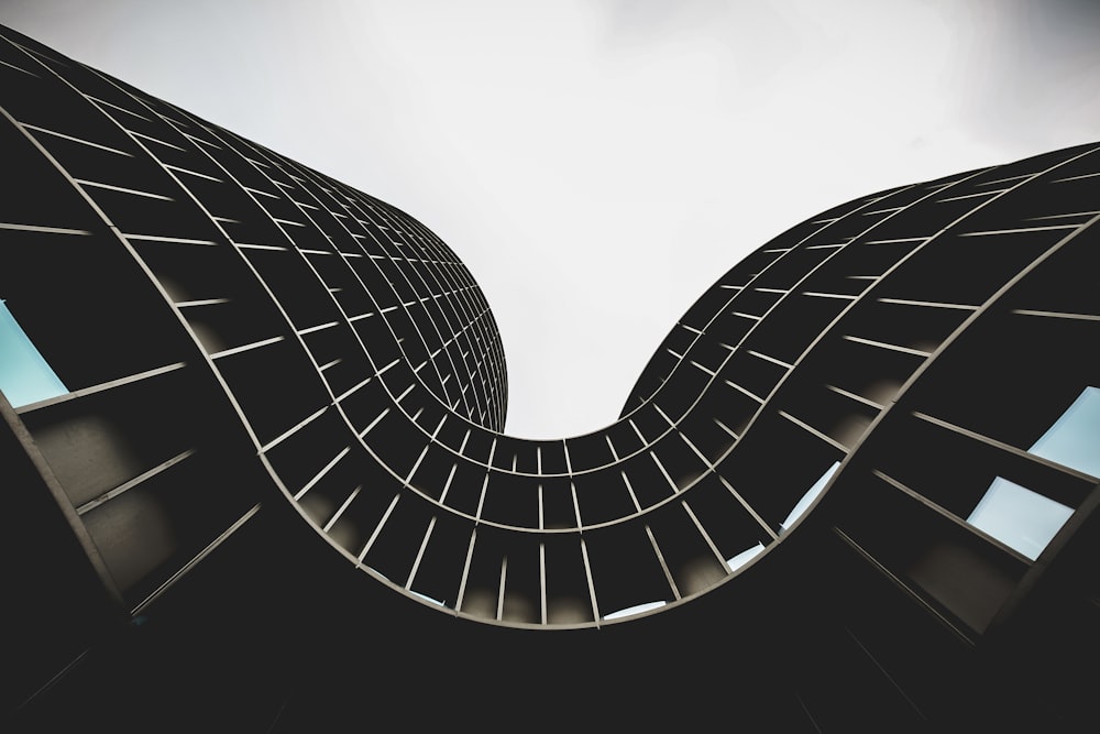 low angle photo of brown concrete building under white sky