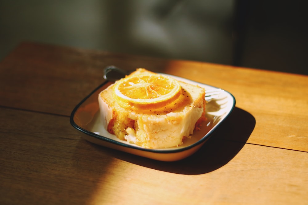 sliced lemon on top of sliced cake on white ceramic plate