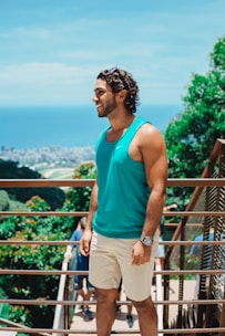 man in teal tank top standing