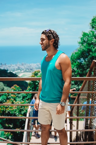 man in teal tank top standing