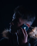 Person making an emergency call with smartphone in hand