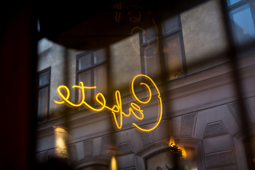 a close up of a neon sign on a building