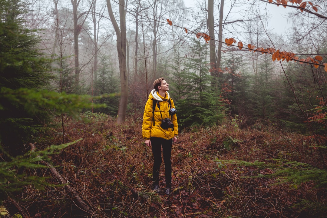 man standing in forest during daytime