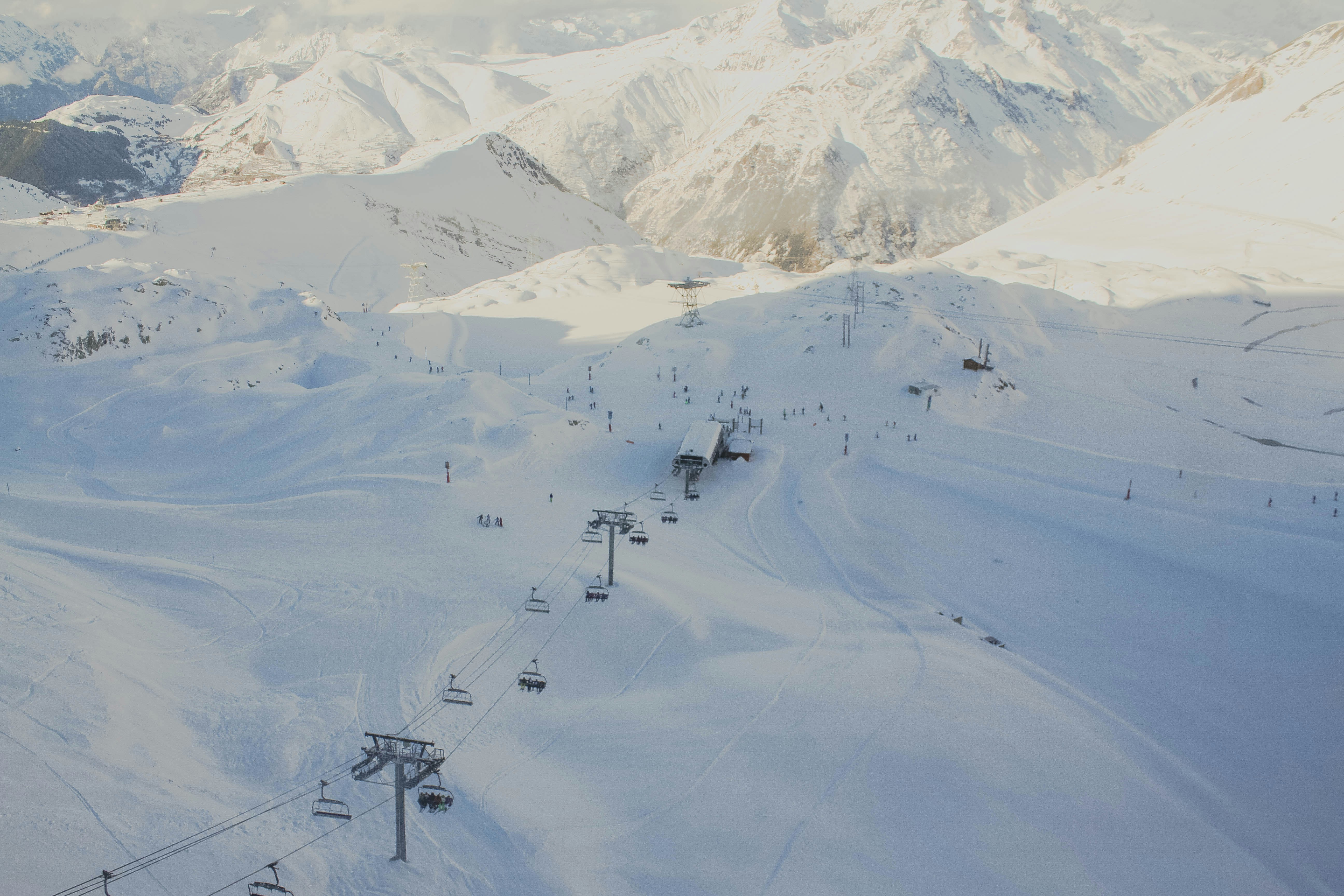 alpine ski lifts crossing a snowy european resort