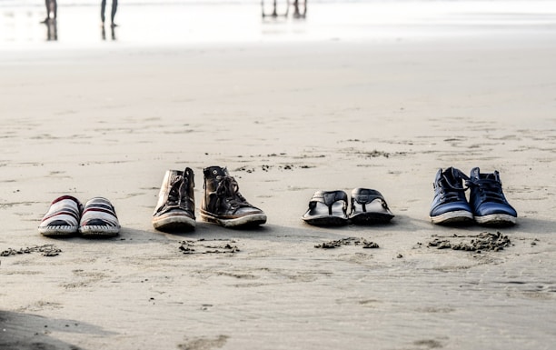 A vibrant display of ultra-light, water-ready footwear on a sandy beach.