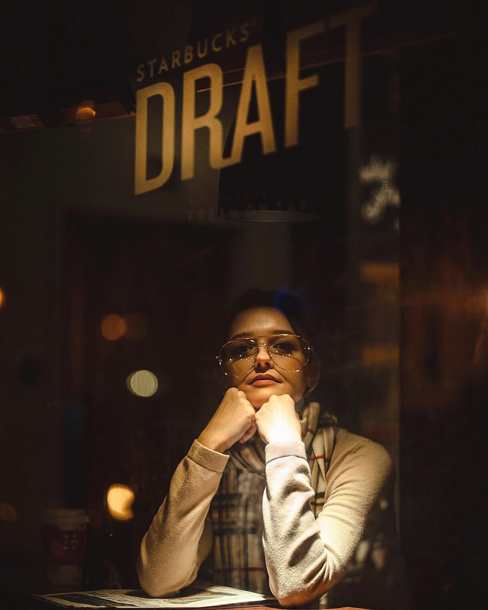 woman wearing sunglasses holding her chin