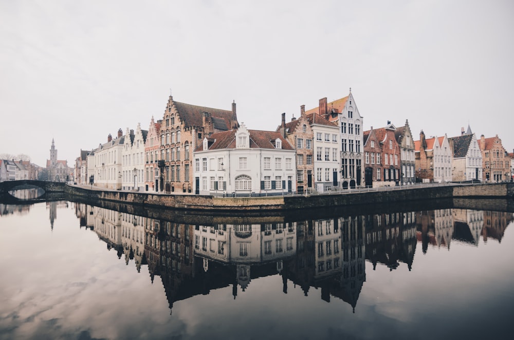 white and brown concrete buildings near bodies of water