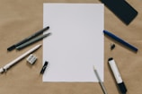 pens near white paper