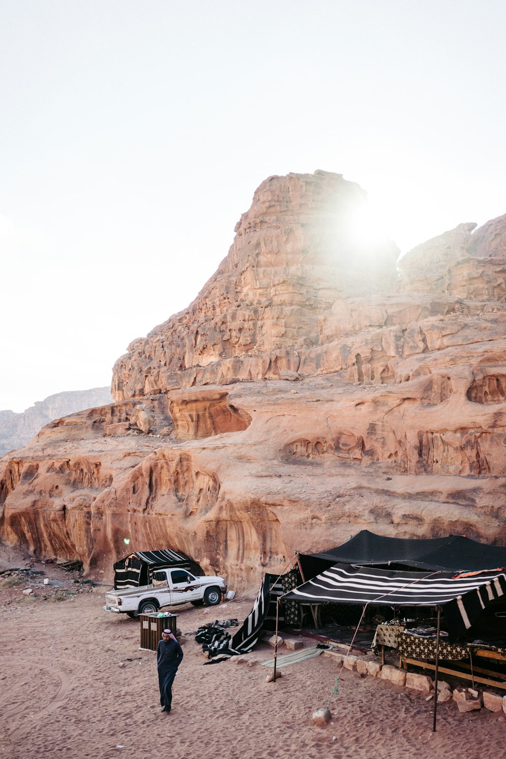 white car on road near brown rock formation during daytime