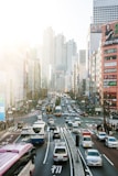 highway road filled with cars surrounded by high rise buildings