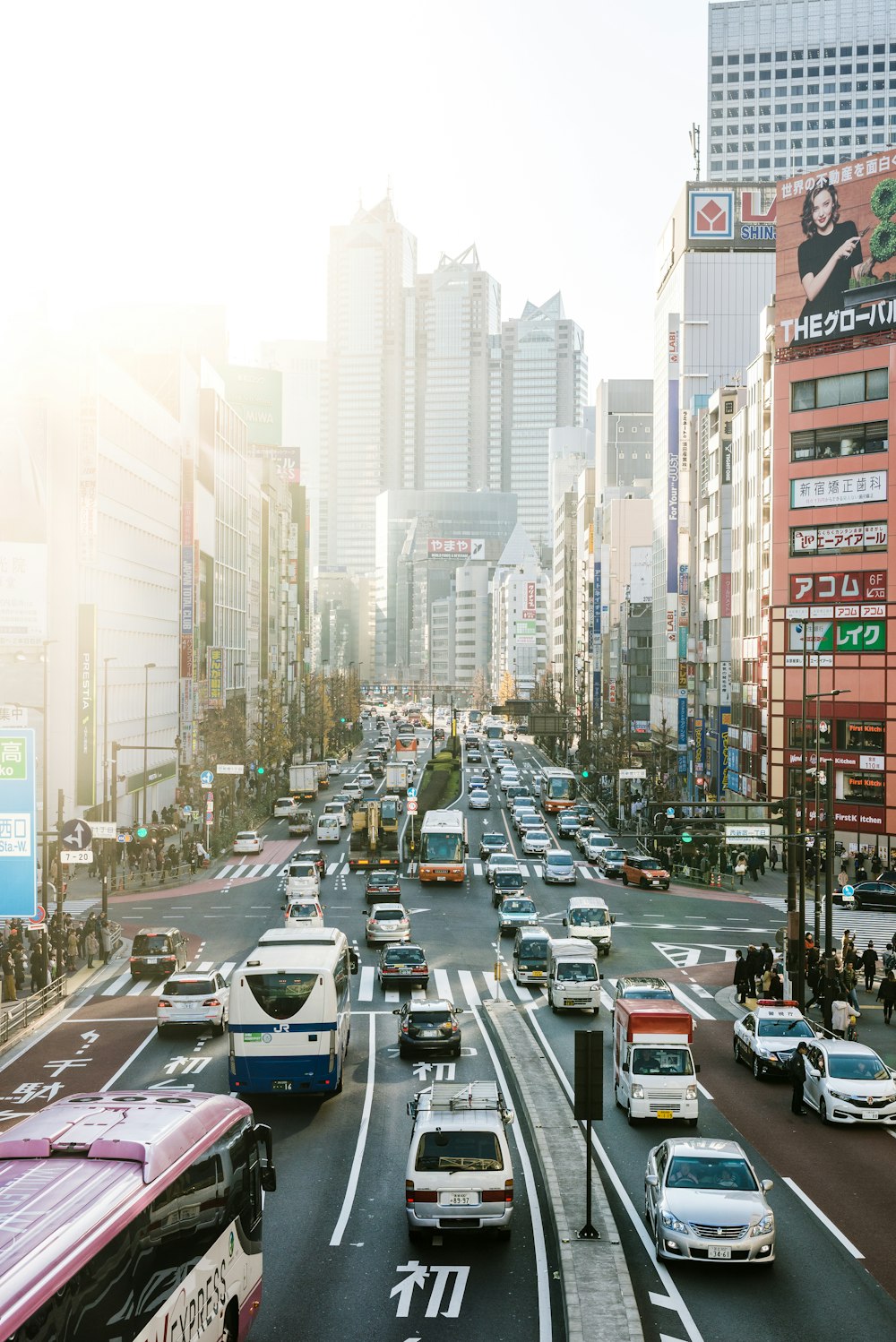 highway road filled with cars surrounded by high rise buildings