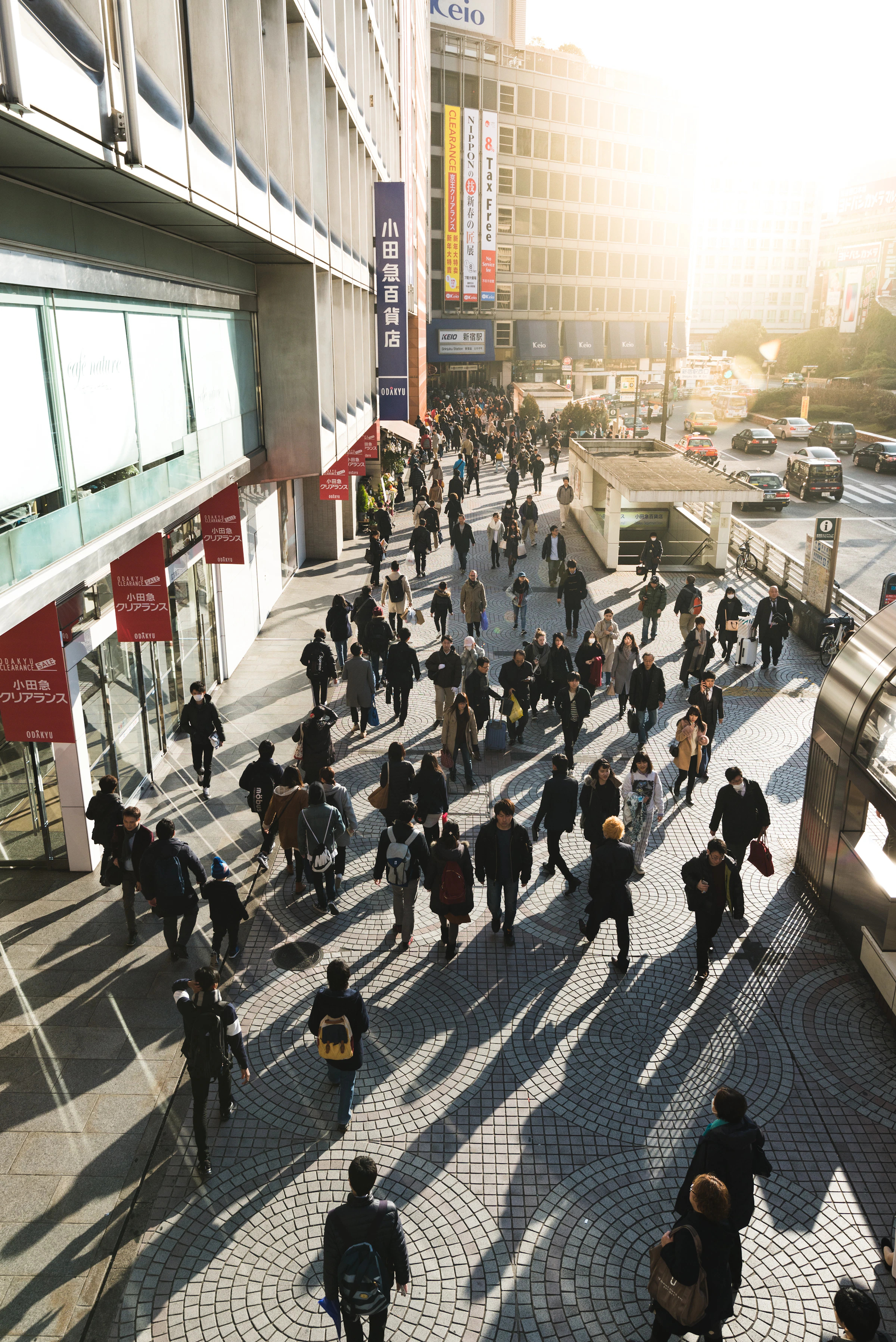 Aerial view of anonymous figures walking on a city street — the surveillance perspective built into the frame