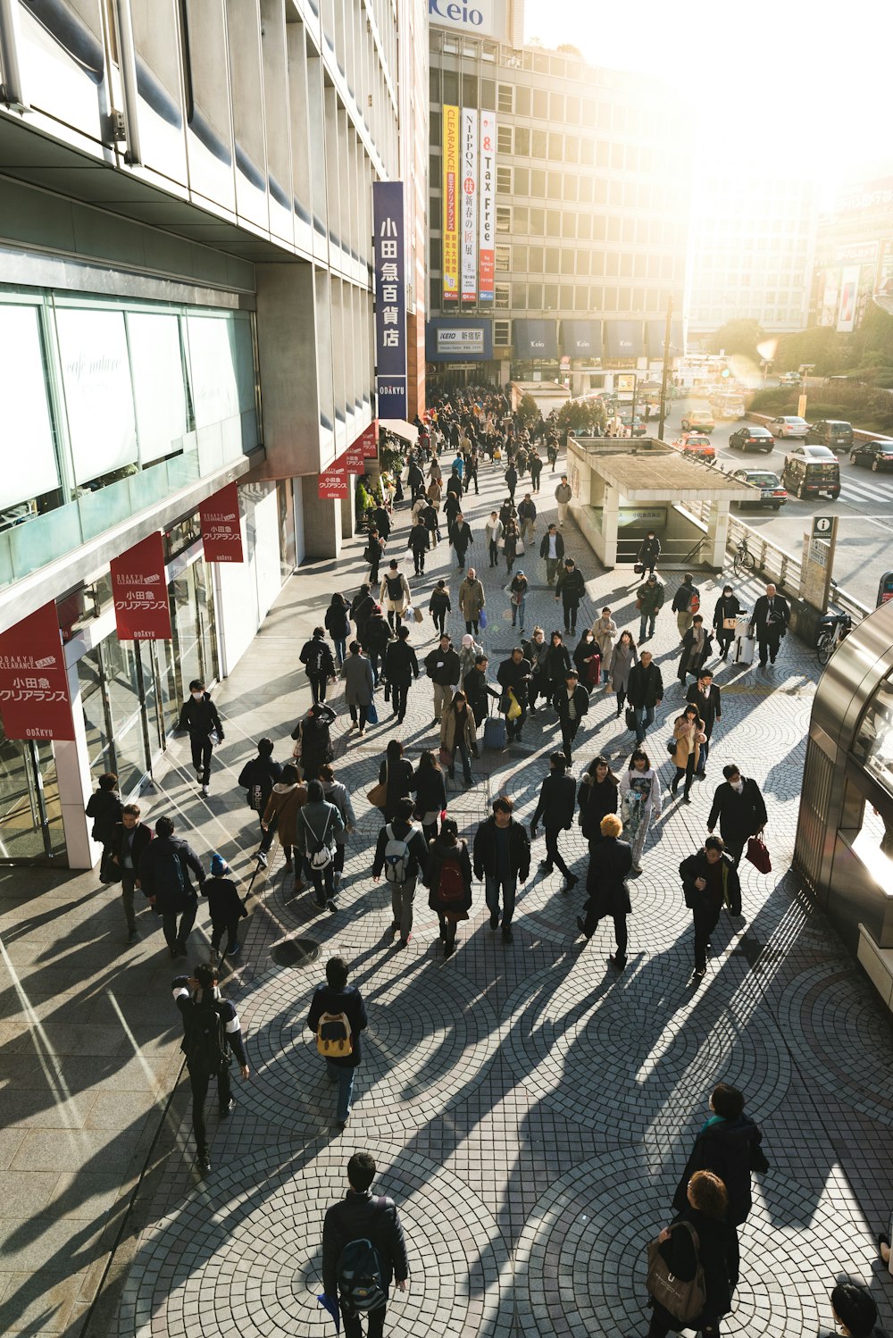 aerial photography of people walking on sidewalk near building during daytime